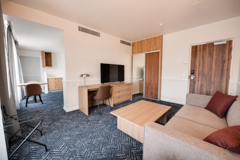 Suite living area with lounge, work desk and television