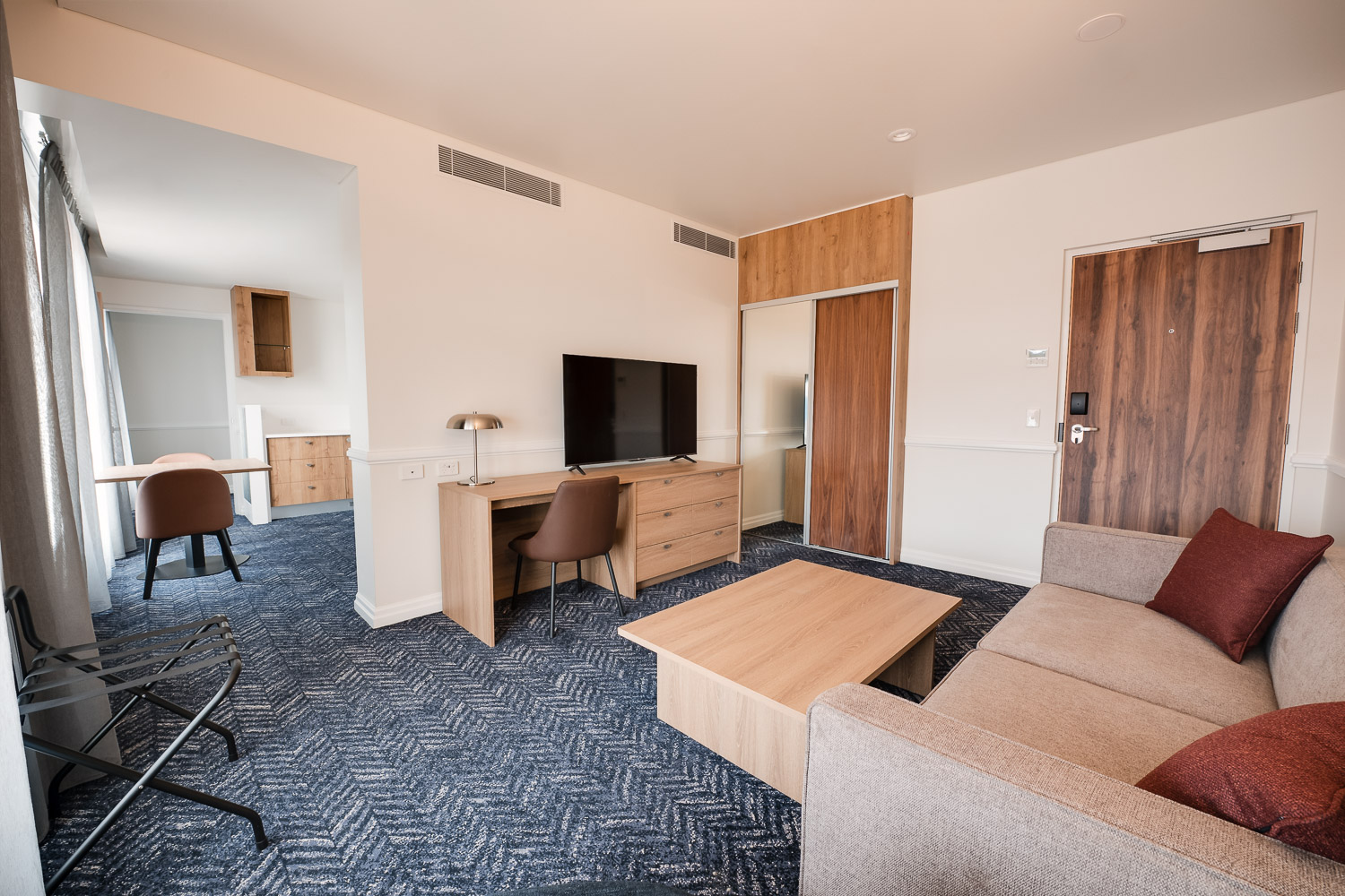 Suite living area with lounge, work desk and television