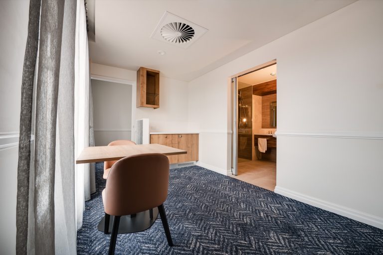 Suite entry with dining table and open bathroom doorway
