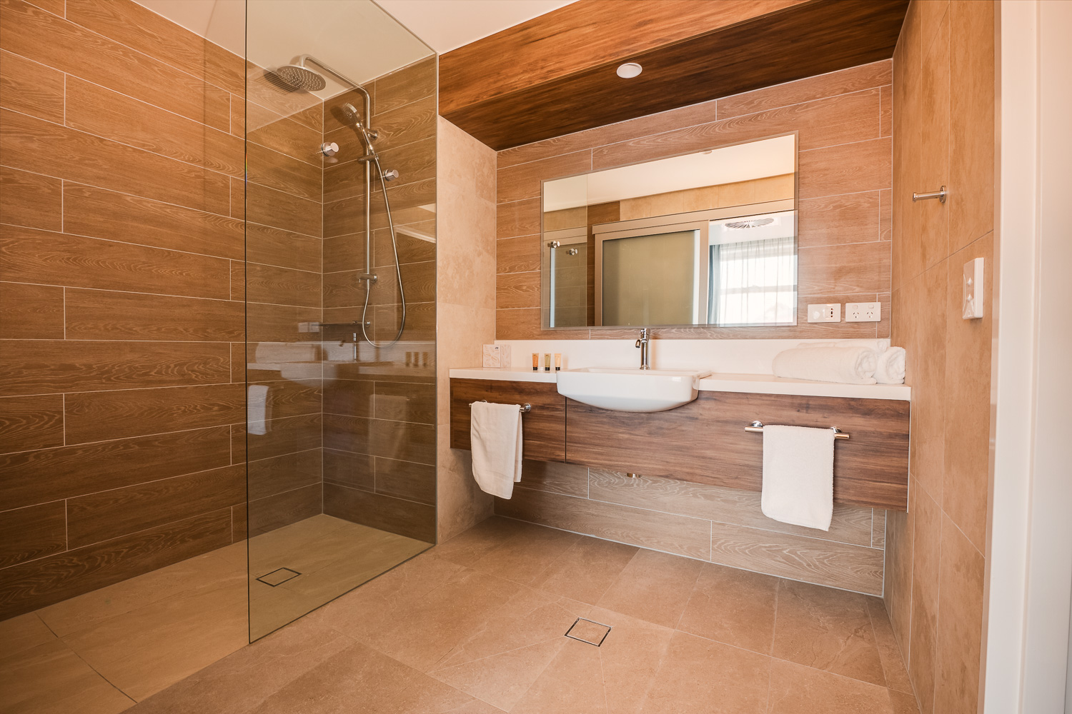 Suite bathroom with walk-in shower, vanity and towel rails