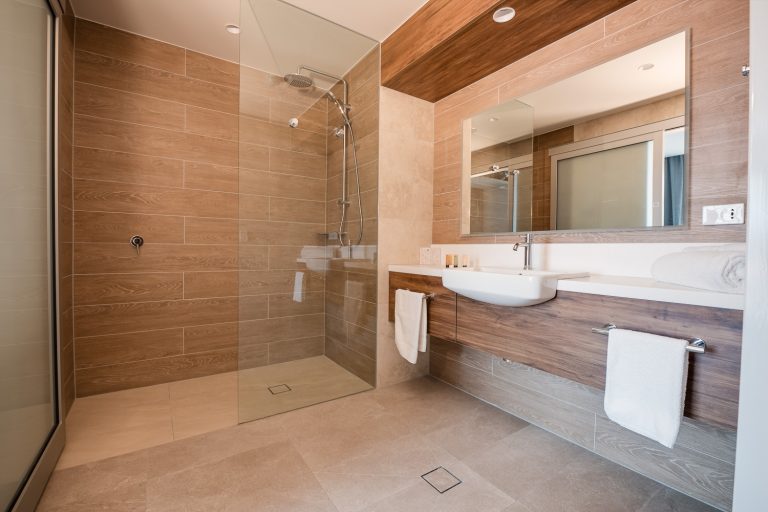 Suite bathroom with a large walk-in shower and timber vanity