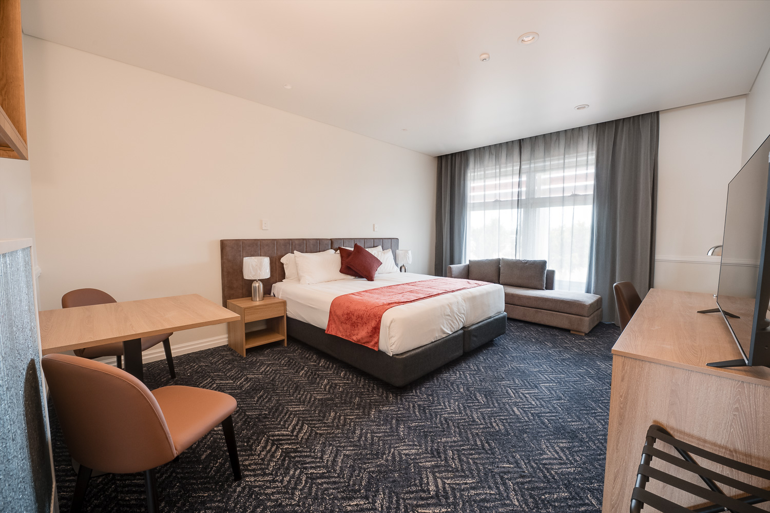 King suite with bed, work desk and lounge chairs